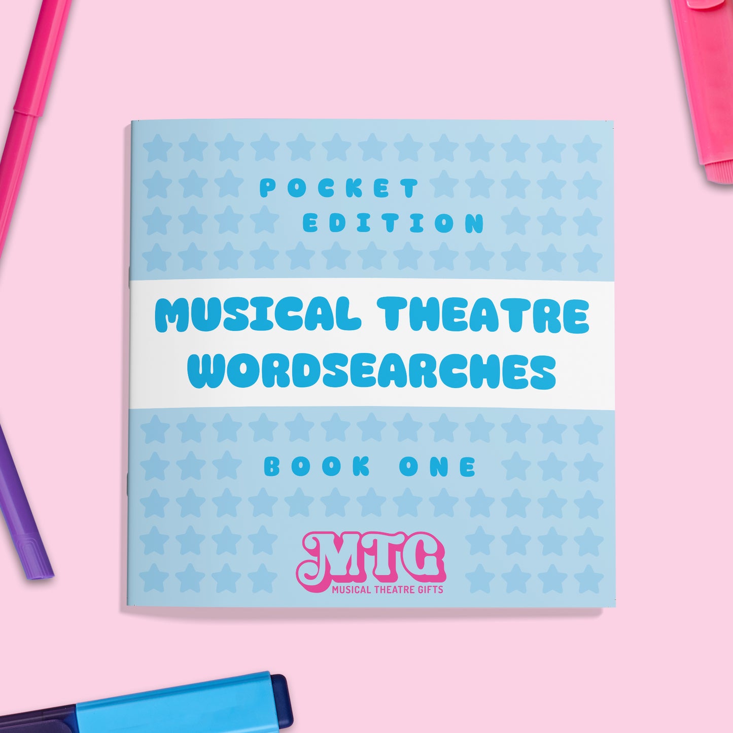 Book titled 'Musical Theatre Wordsearches Book One' with star pattern on a pink background